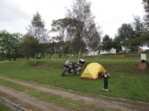 A lonely tent and bike in an otherwise deserted campsite
