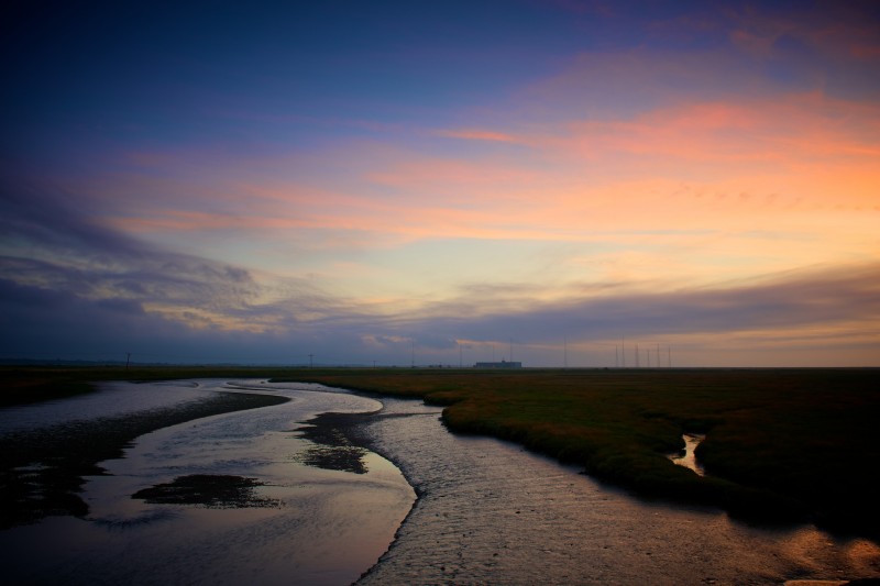 Sunset shot of shingle spit, with experimental radio station in background