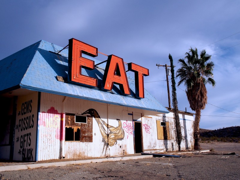 A dilapidated restaurant bearing the legend EAT in huge letters on its roof now only serves graffiti chicken