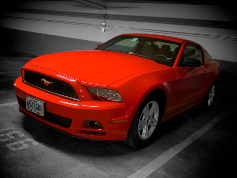 A red Mustang lurks in a hotel garage